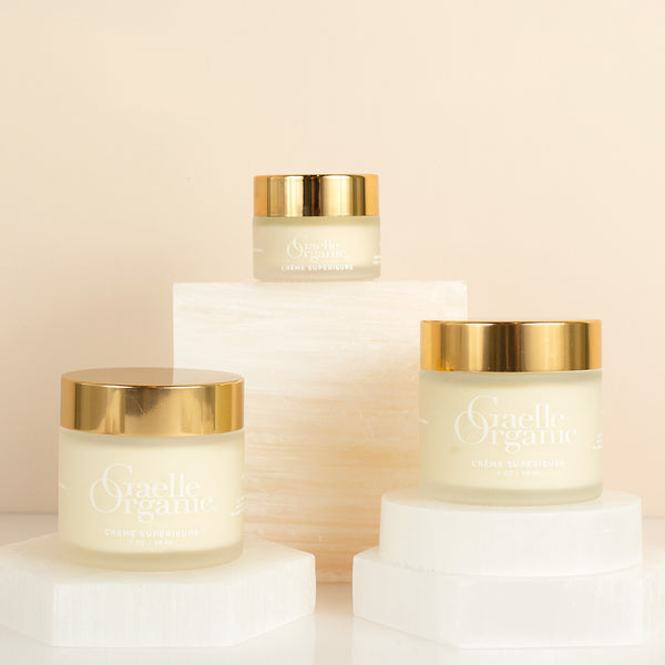 Creme Superiure, an organic moisturizer for dry skin, in full and travel sizes, on white quartz