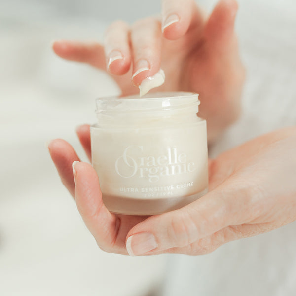 Hands holding Ultra Sensitive Creme, an anti-aging moisturizer for sensitive skin